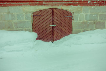 Close up of traditional Norwegian mountain wooden houses, door with snow in stunning nature in Norway