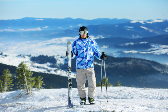 Man on ski piste at snowy resort. Winter vacation