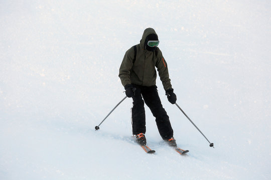 Man skiing at snowy resort. Winter vacation