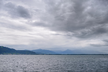 Beautiful panorama of the Alps at lake Constance known as Bodensee in Germany on cloudy autumn day