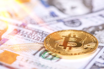 Closeup Golden Bitcoin on the us dollar paper money. Blockchain , cryptocurrency business and investment concept.