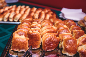 Beautifully decorated catering banquet table with different hamburgers burgers sandwiches on a plate on corporate christmas birthday party event or wedding celebration