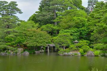 Fototapeta na wymiar Traditional Japanese garden with a pond at the grounds of the old Imperial Palace in Nara, Japan