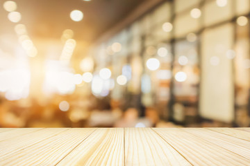 Wood table with Restaurant cafe or coffee shop interior with people abstract defocused blur background