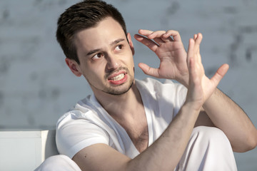 Guy alone in depression in a white room