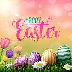 Happy Easter eggs with tulips flower on meadow background