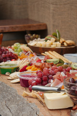 A Delicious Food Platter of Fruit, Nuts, Chesse, Dips, Deli Meats and crackers.
