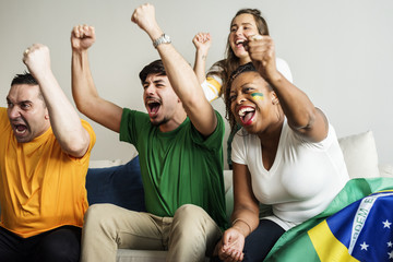 Friends cheering world cup with painted flag