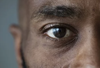 Foto op Aluminium Closeup of an eye of a black man © Rawpixel.com