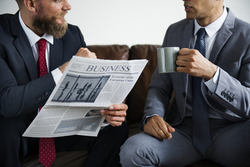 Two businessman sitting on a couch