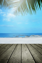 Fototapeta na wymiar Beach background with palm tree and empty wooden.