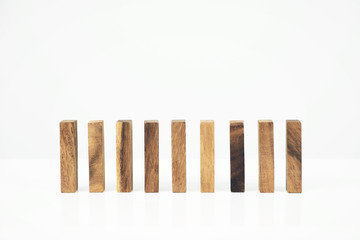 Row of wooden block tower game children on white background.