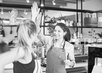 Women give a high five to each other