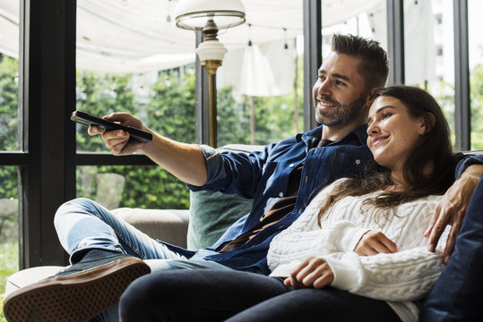 Cheerful Couple Watching TV Together