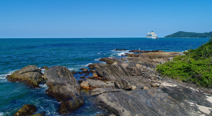 Cruise Ship off Rocky Coastline