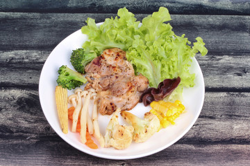 Chicken steak and grilled mixed vegetables .