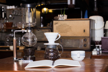 Black coffee cup and wooden desk diary