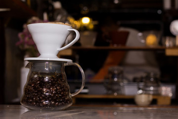 Glass jar with coffee beans on a wooden table