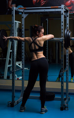 Fototapeta na wymiar Woman with the barbell in the gym 