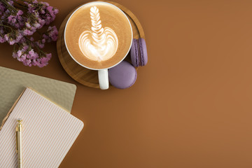 Styled stock photography brown office desk table with blank notebook, computer, supplies and coffee cup. Top view with copy space. Flat lay.