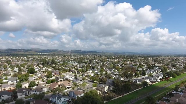 California Neighborhood Flying Upward - Cumulus clouds and homes give movement to a subtle parallax effect