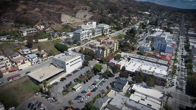 Aerial Flyover - Downtown Ventura - hillside view of city hall and apartments - flying backward