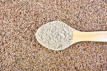 Flour linen in wooden spoon on seeds