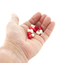 Capsules in red and white in hand