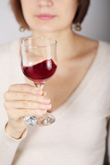 Young woman tasting pink wine