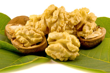 Peeled walnuts close-up. Isolate the core of leaves and shells of walnut. The concept of proper nutrition