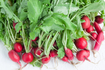 Fresh appetizing radish lying on the desk. Vegetarian food.