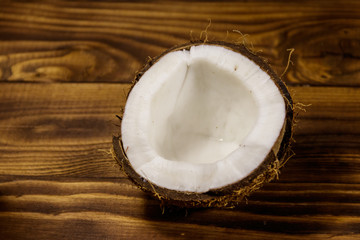 Fresh ripe coconut on rustic wooden table