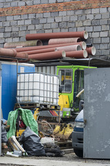 Stacked plastic pipes near the wall.
