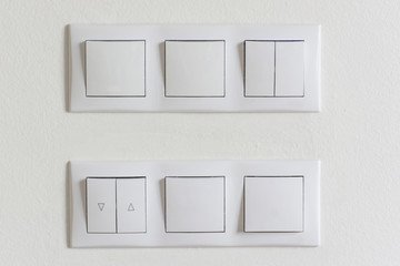 Set of wall switches in white interior.