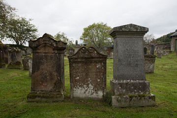 Fototapeta na wymiar Three gravestones in a graveyard in Scotland