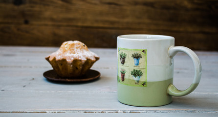 cup of coffee and a cupcake on a plate