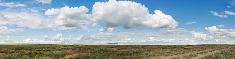 Fototapeta premium Panorama. Landscape. Clouds over the steppe. Tyva. Steppe. Sunny summer day. Outdoors