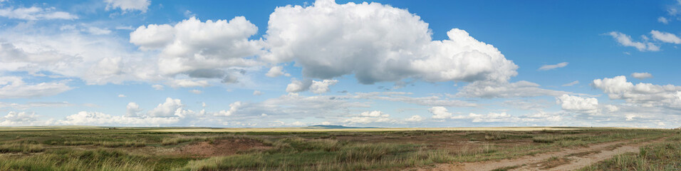 Panorama. Landscape. Clouds over the steppe. Tyva. Steppe. Sunny summer day. Outdoors