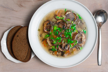 delicious soup in bowl with mushroom and greens