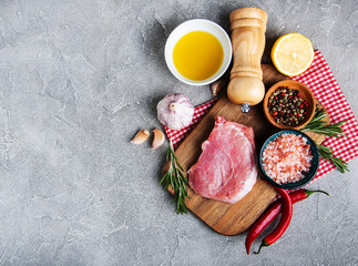 Fresh raw pork chops with spices and herbs