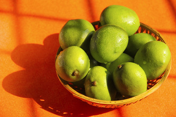Cane bowl with raw mango fruit