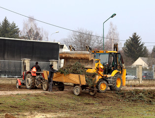 Debowiec/Poland - March 27, 2018: Spring cleaning of green territory in the city. Tractor and...