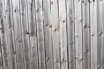 Wooden unpainted weathered fence.