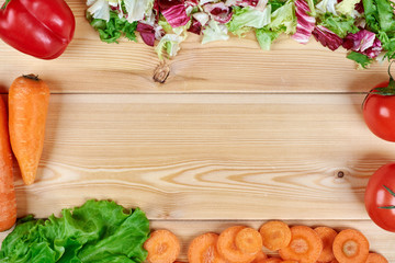 Frame of fresh vegetables on wooden background. Healthy natural food on table with copy space on cutting board . Cooking ingredients top view, mockup for recipe or menu.