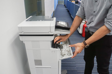 close up businessman in grey shirt open the toner cartridge for inkjet printer