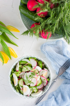 Salad with radish, cucumber and egg, top view, selective focus