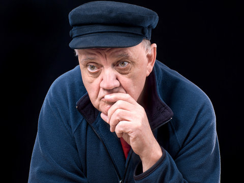 portrait vieil homme trapu de face sur fond noir