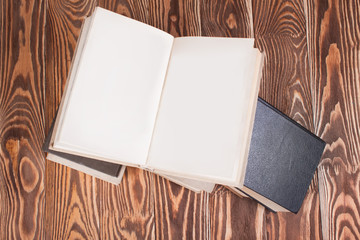 Fototapeta premium Open books on wood desk