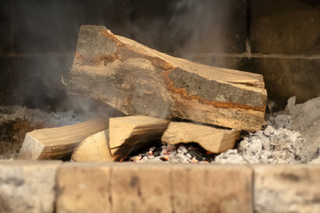 burning wood in brick fireplace in country cottage