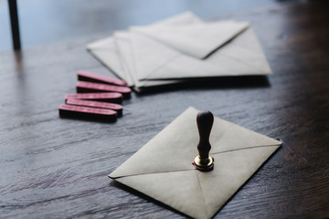Man makes the stamp using sealing wax on the envelope